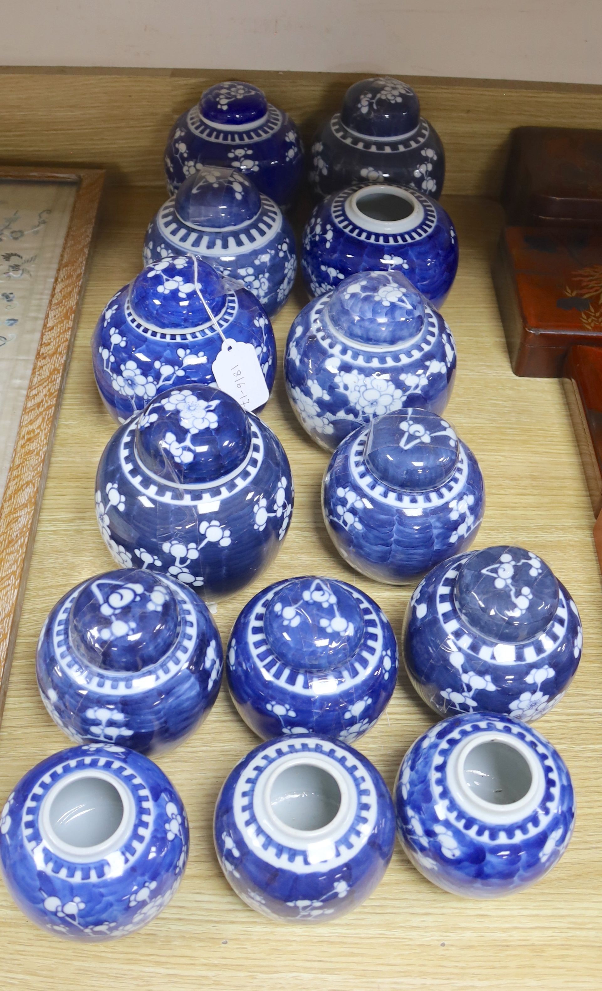 Fourteen Chinese blue and white prunus jars some with covers